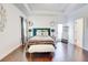 Bright main bedroom featuring a tray ceiling, hardwood floors and elegant decor at 4450 Heatherwood Sw Dr, Atlanta, GA 30331