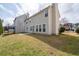 Exterior view of the home's side and backyard featuring a well-maintained lawn and concrete patio at 4728 Sedum Way, Atlanta, GA 30349