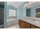 Bright bathroom featuring a soaking tub, double sink vanity, and separate shower at 4728 Sedum Way, Atlanta, GA 30349