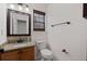 A well-maintained bathroom featuring a granite counter and a framed mirror at 4728 Sedum Way, Atlanta, GA 30349