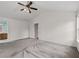 A spacious carpeted bedroom featuring vaulted ceiling, natural light and ceiling fan at 4728 Sedum Way, Atlanta, GA 30349