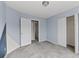 Cozy bedroom with soft grey carpet, open closet and ensuite door at 4728 Sedum Way, Atlanta, GA 30349