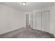 A spacious bedroom with carpet, light walls, and a closet with white doors at 4728 Sedum Way, Atlanta, GA 30349