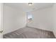 Bedroom featuring neutral paint, grey carpets and a window with a neighborhood view at 4728 Sedum Way, Atlanta, GA 30349