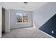 Bedroom with a geometric accent wall, a large window, and a closet for storage at 4728 Sedum Way, Atlanta, GA 30349