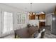 Dining room featuring a chandelier, table with seating and an adjacent kitchen area at 4728 Sedum Way, Atlanta, GA 30349