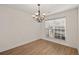 Neutral dining room with hardwood floors, modern chandelier, and natural light from the window at 4728 Sedum Way, Atlanta, GA 30349