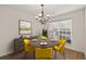 Cozy dining room with modern decor featuring a round table and yellow chairs for a modern look at 4728 Sedum Way, Atlanta, GA 30349