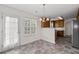 View of the dining room featuring a chandelier, table with seating and access to the rear of the home at 4728 Sedum Way, Atlanta, GA 30349