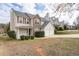 Two-story home featuring stone accents, vinyl siding, a two-car garage, and a cozy front porch at 4728 Sedum Way, Atlanta, GA 30349