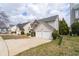 Two-story home featuring stone accents, vinyl siding, a two-car garage, and a cozy front porch at 4728 Sedum Way, Atlanta, GA 30349