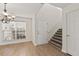 Hallway with hardwood floors leading to the staircase and featuring lots of natural light at 4728 Sedum Way, Atlanta, GA 30349