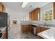 A functional kitchen with ample cabinet space, stainless steel appliances, and a view into the living area at 4728 Sedum Way, Atlanta, GA 30349