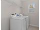 Bright laundry room featuring a washer, dryer and overhead wire shelving for storage at 4728 Sedum Way, Atlanta, GA 30349