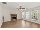 Bright living room with hardwood floors, a fireplace, and natural light from the large windows at 4728 Sedum Way, Atlanta, GA 30349