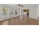 Bright living room with hardwood floors, ceiling fan, neutral walls and natural light, open to kitchen at 4728 Sedum Way, Atlanta, GA 30349