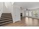 Open living space featuring stairs, fireplace, ceiling fan and natural light at 4728 Sedum Way, Atlanta, GA 30349