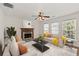 Bright living room with fireplace, ceiling fan, plush seating and plenty of natural light at 4728 Sedum Way, Atlanta, GA 30349