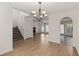 Open living space with hardwood floors, stairs, neutral walls, and a modern chandelier at 4728 Sedum Way, Atlanta, GA 30349