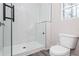 A bathroom featuring a glass enclosed shower with white subway tile and a toilet at 30 Sportsman Path, Dallas, GA 30157