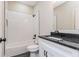 A full bathroom with a subway tile shower and granite countertops offers stylish convenience at 30 Sportsman Path, Dallas, GA 30157
