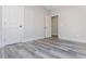 An empty bedroom with gray vinyl floors and neutral walls offers a blank canvas for customization at 30 Sportsman Path, Dallas, GA 30157