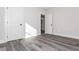 A bright bedroom with a modern gray wood-look flooring and neutral paint at 30 Sportsman Path, Dallas, GA 30157