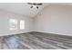 A spacious bedroom with vaulted ceilings, gray vinyl flooring, and large windows offers comfort and style at 30 Sportsman Path, Dallas, GA 30157