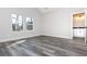 Bedroom with hardwood flooring, white trim, and a bright window with neutral walls and attached bath at 30 Sportsman Path, Dallas, GA 30157