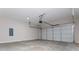 Spacious garage with concrete floor and a grey door with automatic door opener at 30 Sportsman Path, Dallas, GA 30157