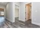 Hallway featuring gray floors and multiple doorways to other rooms at 30 Sportsman Path, Dallas, GA 30157
