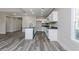 A modern kitchen with white cabinets, gray countertops, an island, and gray floors at 30 Sportsman Path, Dallas, GA 30157