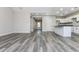 A large living room with gray floors, a kitchen, and a view of the entryway at 30 Sportsman Path, Dallas, GA 30157
