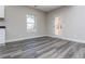 Living room with gray hardwood flooring and trim, plus a window and glass door at 30 Sportsman Path, Dallas, GA 30157
