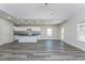 Bright, open-concept living room featuring hard surface floors, recessed lighting, and white cabinets at 30 Sportsman Path, Dallas, GA 30157