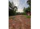 View of cleared property with a red barn and trees surrounding the perimeter at 30 Sportsman Path, Dallas, GA 30157