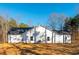Rear view of home with white siding, dark roof, and many windows providing natural light at 30 Sportsman Path, Dallas, GA 30157