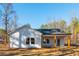 Rear view of home with white siding, dark roof, and many windows providing natural light at 30 Sportsman Path, Dallas, GA 30157