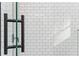 A close up of a glass shower door with matte black hardware and white subway tiles at 30 Sportsman Path, Dallas, GA 30157