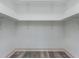 An open and empty walk-in closet with white walls and shelving offers a large space for storage and organization at 30 Sportsman Path, Dallas, GA 30157