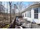 The back deck features a wooded view and a table with seating and lots of light at 3405 Lake Valley Way, Douglasville, GA 30135