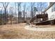 Large lot backyard featuring mature trees, second story deck and walkway at 3405 Lake Valley Way, Douglasville, GA 30135