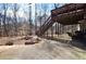 Backyard featuring a patio and second story deck with stairs leading to a large wooded back yard at 3405 Lake Valley Way, Douglasville, GA 30135