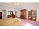 Spacious main bedroom featuring classic wooden furniture and light-filled windows at 3405 Lake Valley Way, Douglasville, GA 30135