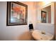 Stylish powder room featuring framed artwork, sink, and decorative accents at 3405 Lake Valley Way, Douglasville, GA 30135
