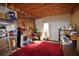 A large storage room with exposed wood ceiling, tools, red carpet, shelving, and a double door at 3405 Lake Valley Way, Douglasville, GA 30135