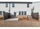 Back of the home features stone accents, and a small patio space at 3545 Bexton Dr, Duluth, GA 30097