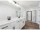 Bathroom featuring double sink vanity with white countertops and framed mirror at 3545 Bexton Dr, Duluth, GA 30097