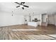 Spacious living room featuring wood floors, contemporary lighting, and a clear view to the staircase and kitchen at 3545 Bexton Dr, Duluth, GA 30097