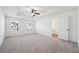 Spacious main bedroom with carpet, tray ceiling, ceiling fan, and large windows at 3545 Bexton Dr, Duluth, GA 30097